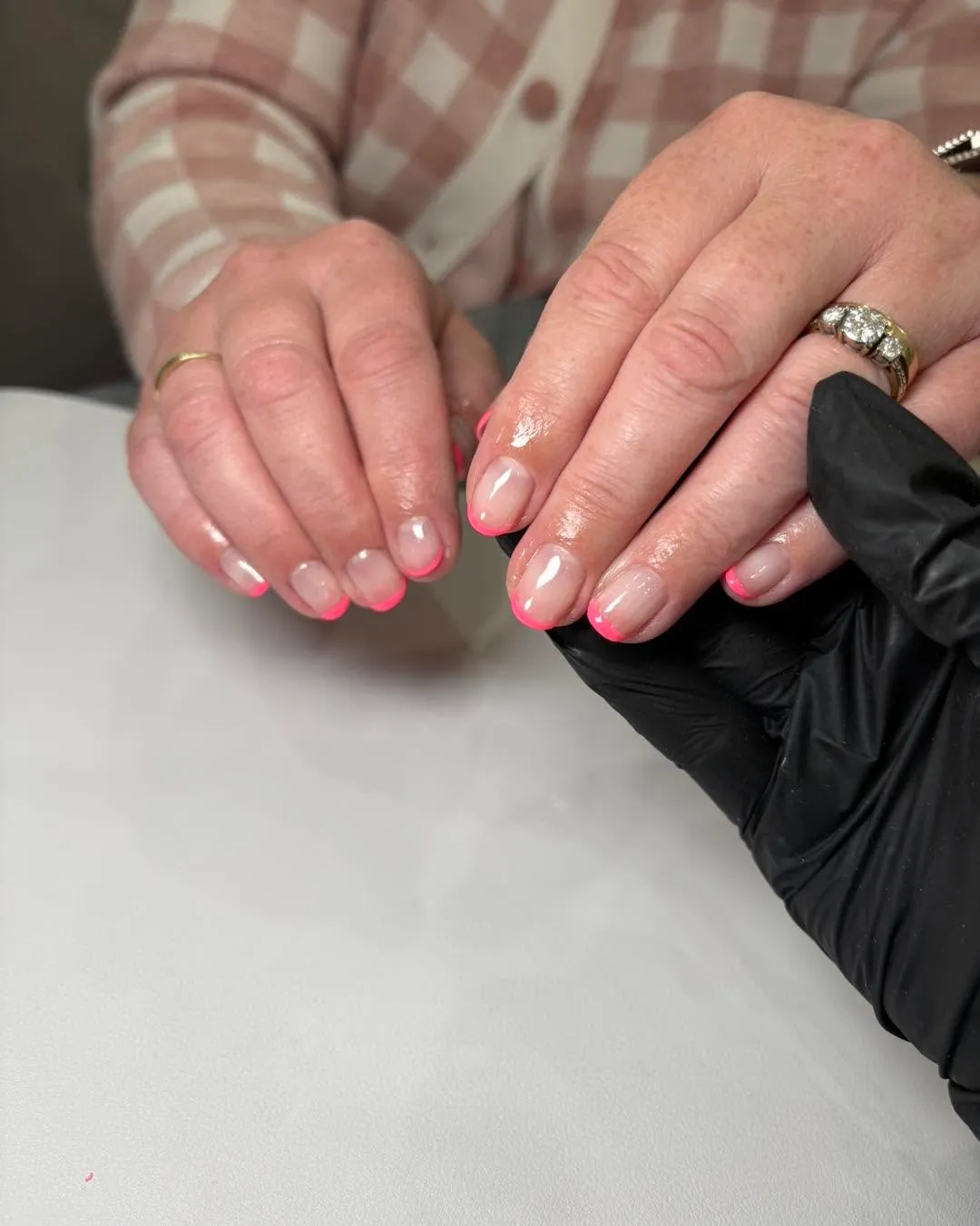 Natural gel French manicure with sheer blush base and bright pink tips